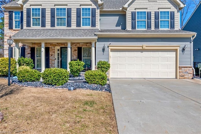 view of front of house with a garage, stone siding, concrete driveway, and a shingled roof