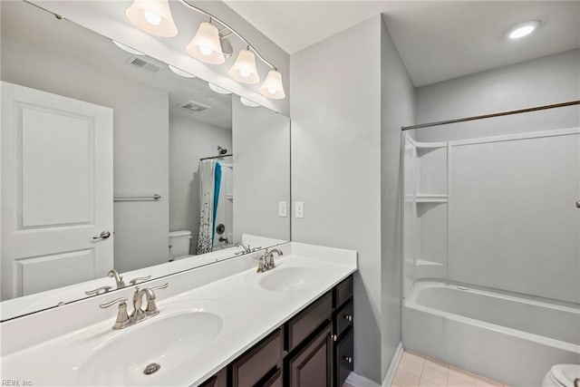 full bath with visible vents, toilet, shower / bath combo, and a sink