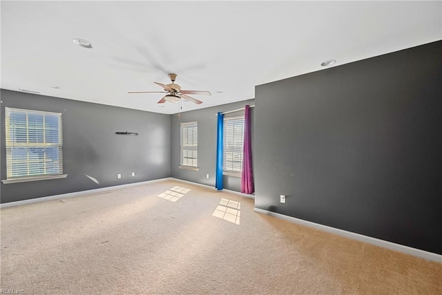 empty room with baseboards, a ceiling fan, and carpet flooring