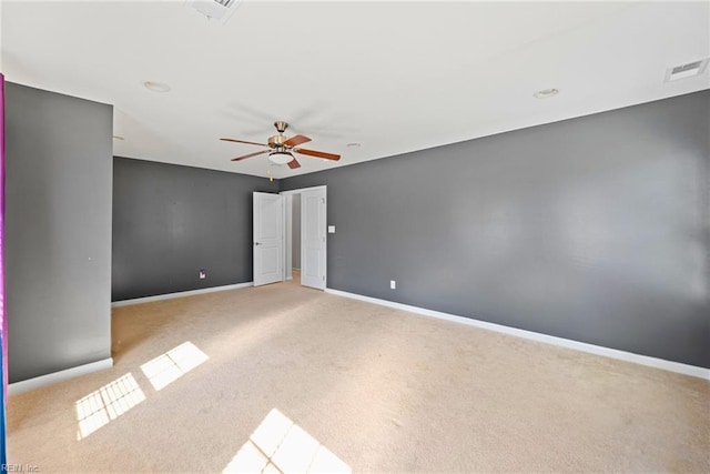 spare room featuring visible vents, carpet flooring, baseboards, and ceiling fan