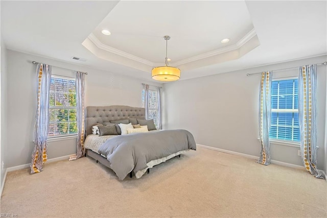 carpeted bedroom featuring visible vents, a raised ceiling, baseboards, and ornamental molding