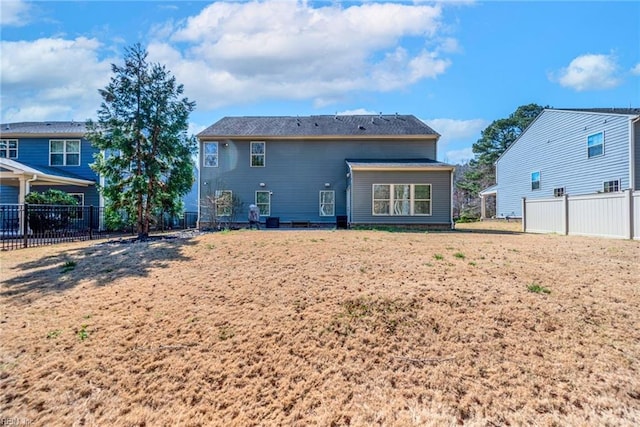 rear view of house with fence