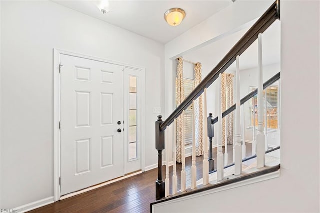 entrance foyer with stairs, baseboards, and wood finished floors