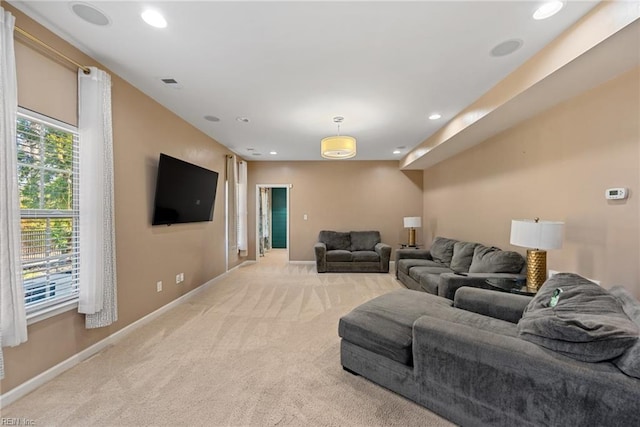 living room with visible vents, recessed lighting, baseboards, and light carpet