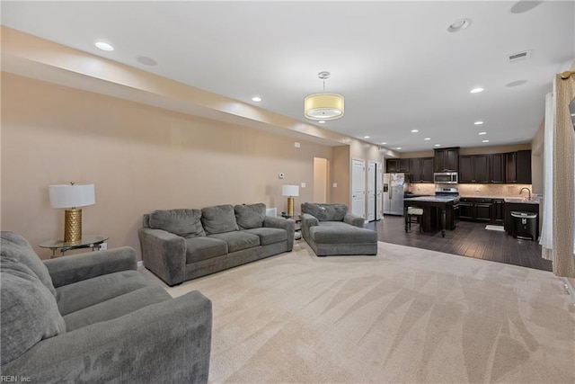 living room with recessed lighting, visible vents, and dark wood-style flooring