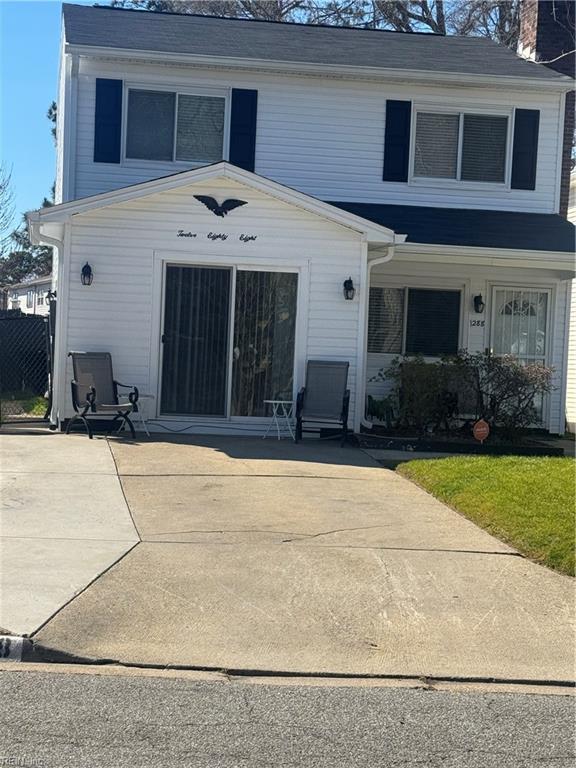 view of front of home with a chimney and fence