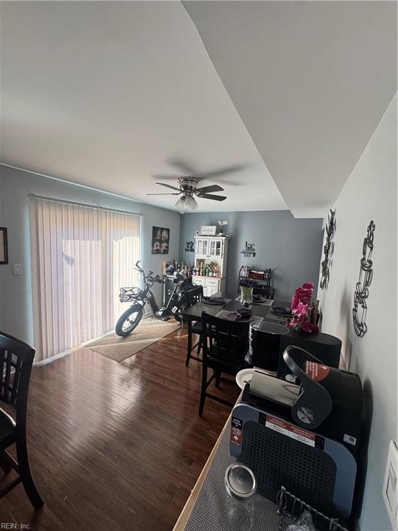 living room featuring wood finished floors and a ceiling fan