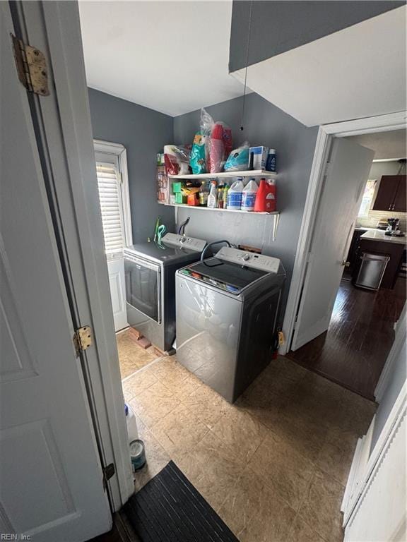 clothes washing area featuring laundry area and washer and clothes dryer