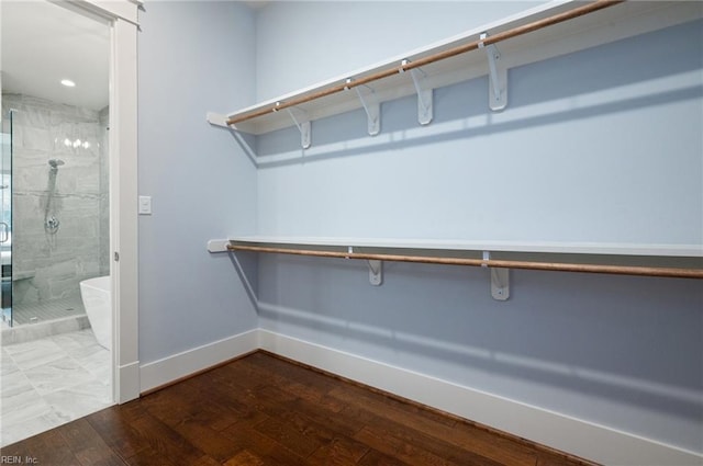 walk in closet featuring wood finished floors