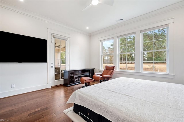 bedroom featuring dark wood-type flooring, multiple windows, visible vents, and ornamental molding