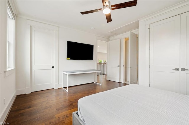 bedroom with ceiling fan, crown molding, baseboards, and wood-type flooring