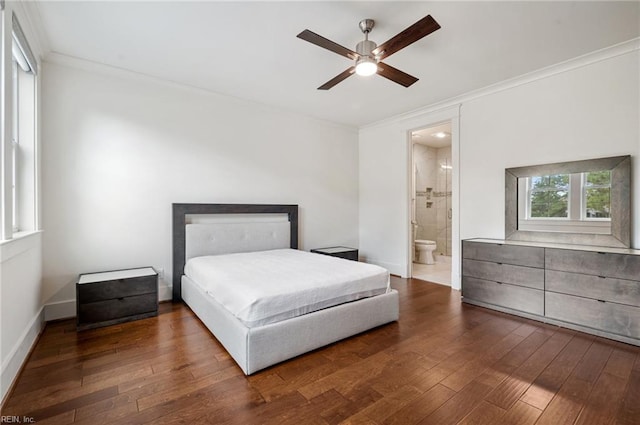 bedroom featuring hardwood / wood-style flooring, ensuite bath, crown molding, baseboards, and ceiling fan