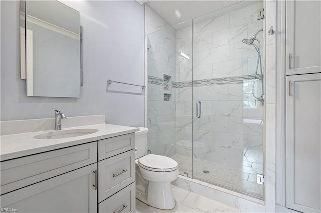 bathroom with vanity, toilet, marble finish floor, and a shower stall