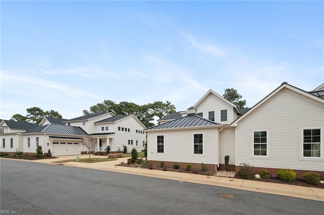 modern farmhouse featuring a residential view, metal roof, and a standing seam roof