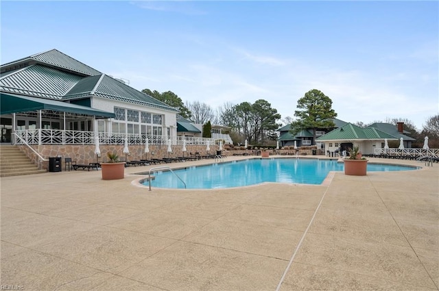 community pool with a patio area