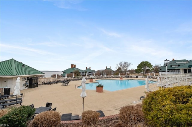 pool featuring a patio and fence