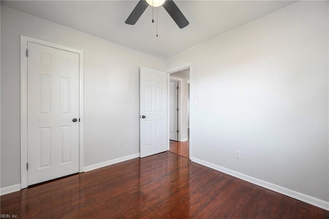 unfurnished bedroom featuring a ceiling fan, wood finished floors, and baseboards