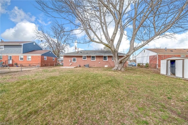 view of yard featuring a shed, an outdoor structure, and fence