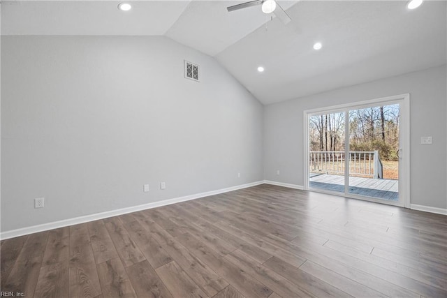 empty room featuring visible vents, ceiling fan, baseboards, lofted ceiling, and dark wood-style floors