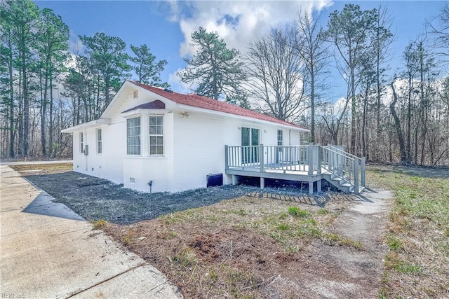 view of home's exterior featuring crawl space and a deck