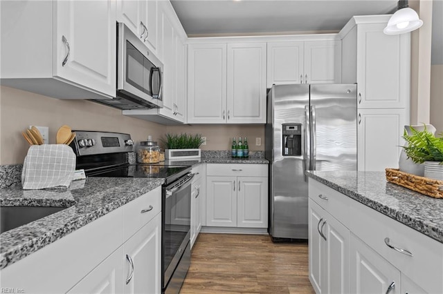 kitchen with white cabinetry, dark wood-style flooring, and appliances with stainless steel finishes