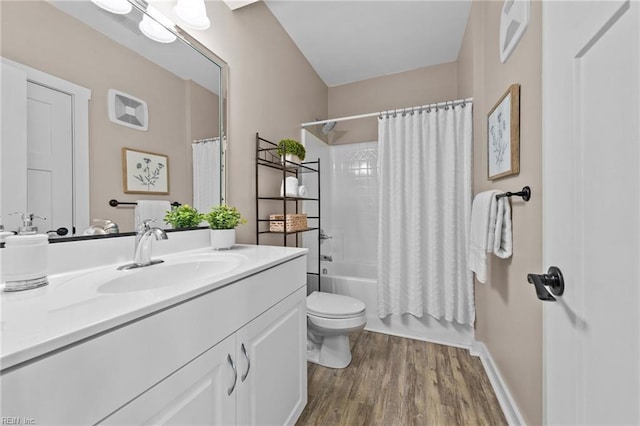 bathroom featuring baseboards, toilet, wood finished floors, vanity, and shower / bathtub combination with curtain