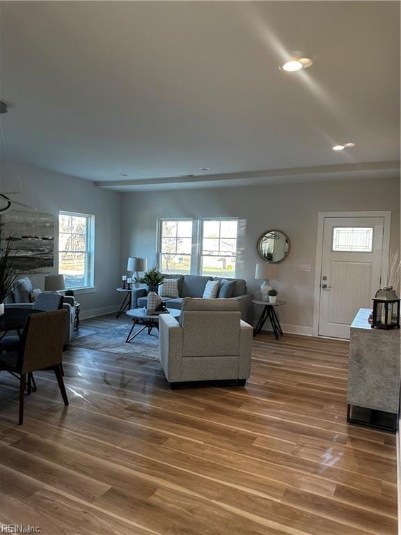 living room featuring recessed lighting, wood finished floors, and baseboards