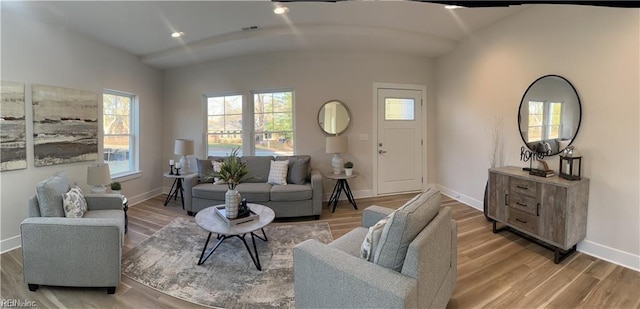 living area featuring visible vents, recessed lighting, baseboards, and wood finished floors