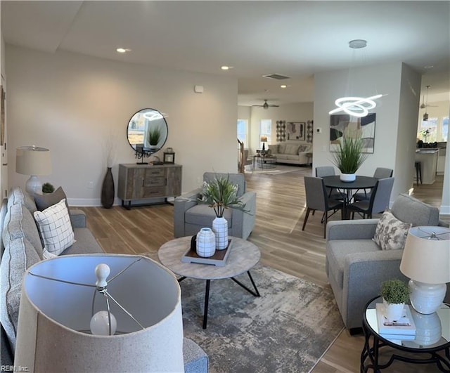 living room featuring visible vents, recessed lighting, baseboards, and wood finished floors