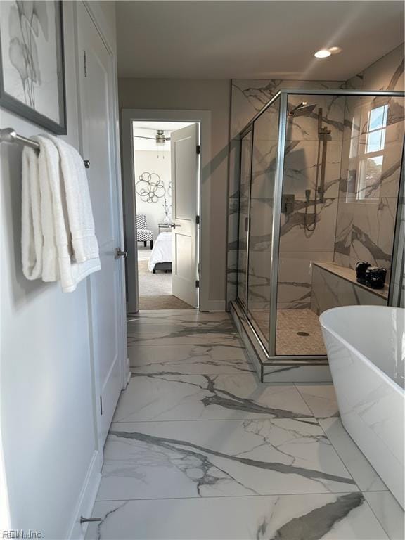 ensuite bathroom with a marble finish shower, recessed lighting, a freestanding tub, marble finish floor, and ensuite bath