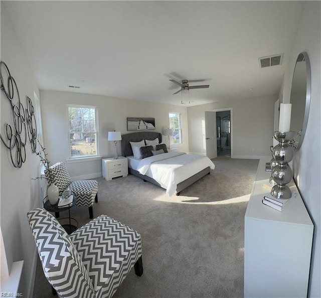 carpeted bedroom with a ceiling fan, baseboards, and visible vents