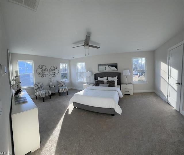 carpeted bedroom with a ceiling fan, visible vents, and baseboards