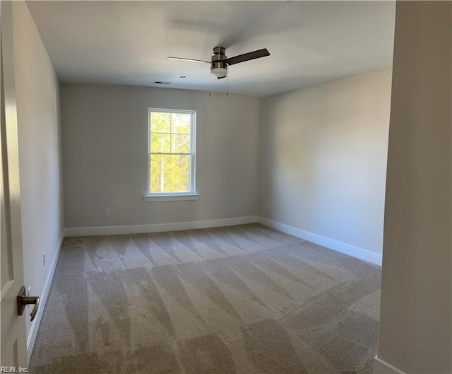 empty room featuring visible vents, ceiling fan, baseboards, and carpet floors