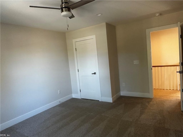 unfurnished bedroom with carpet flooring, a ceiling fan, and baseboards