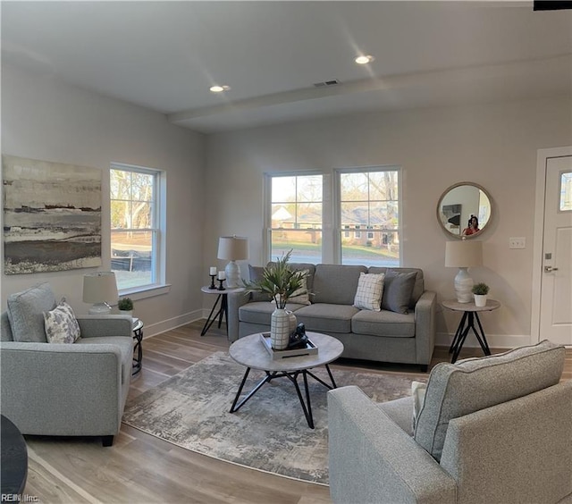 living room featuring recessed lighting, visible vents, baseboards, and light wood-style floors