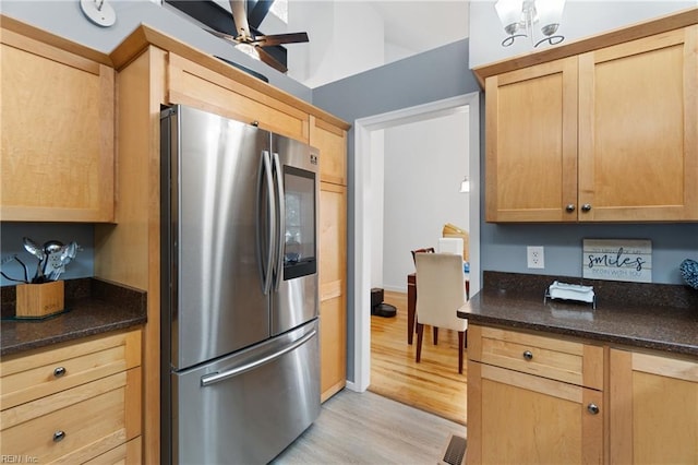 kitchen with visible vents, light brown cabinets, dark stone counters, light wood-style flooring, and smart refrigerator