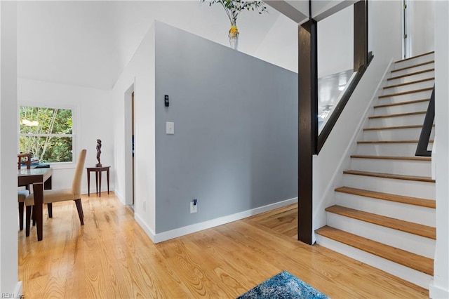 stairs with baseboards and wood finished floors