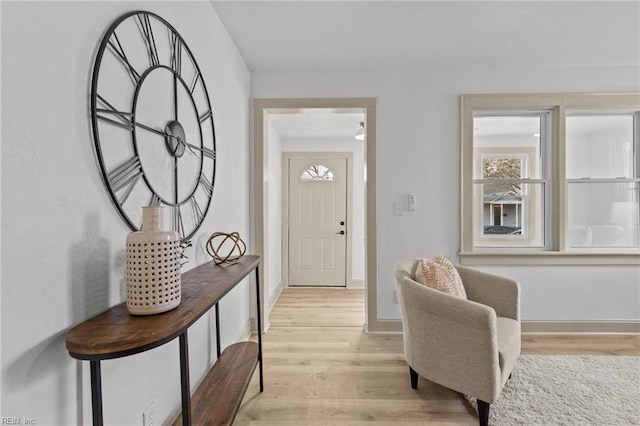 foyer featuring light wood-style floors and baseboards