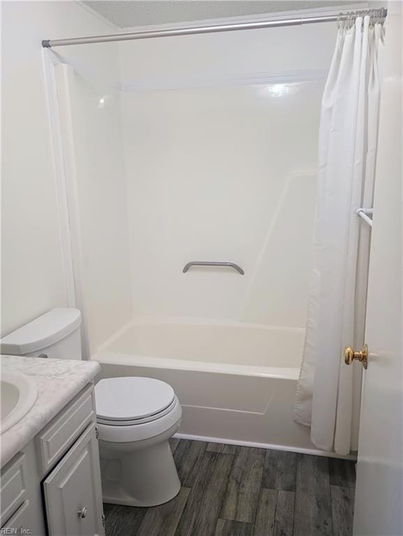 bathroom with vanity, toilet, wood finished floors, and shower / tub combo with curtain