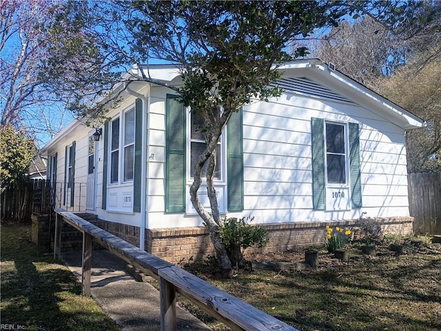 view of side of property featuring fence