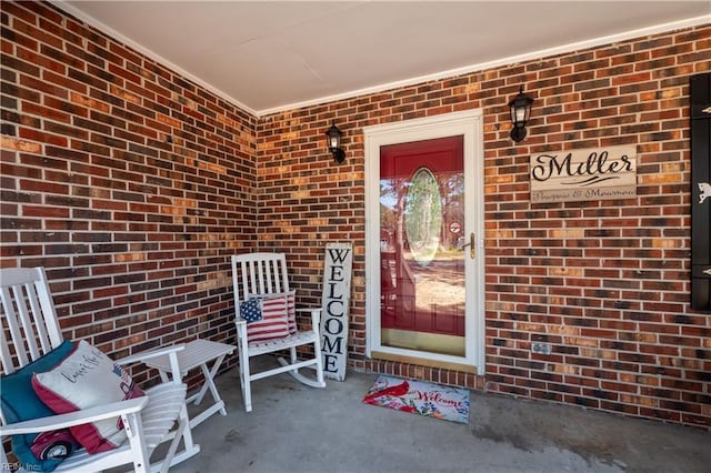 view of exterior entry with brick siding