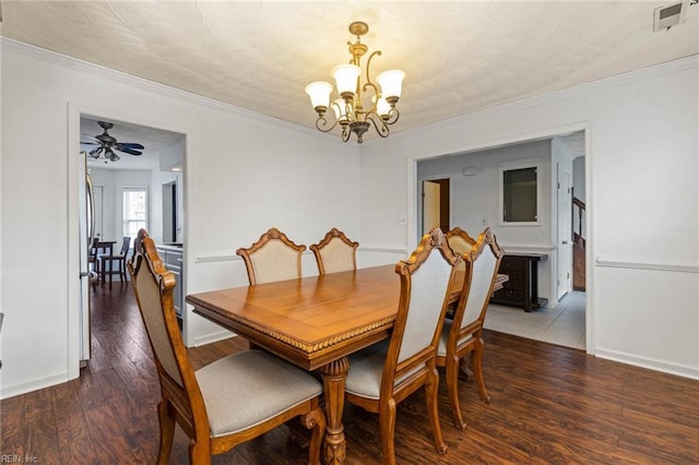 dining room featuring visible vents, wood finished floors, and ornamental molding