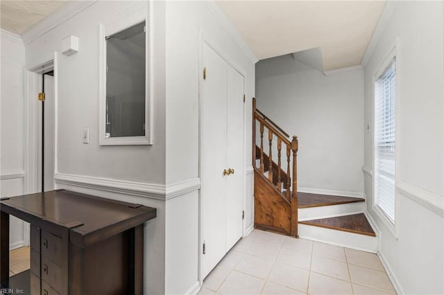 corridor with stairway, a healthy amount of sunlight, and crown molding