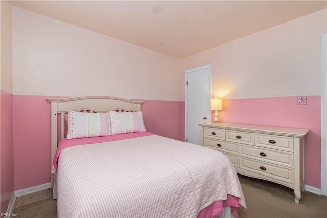 bedroom featuring dark colored carpet and baseboards