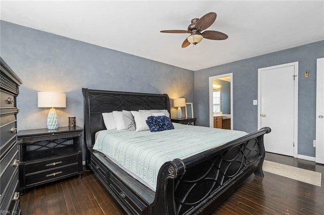 bedroom with connected bathroom, baseboards, dark wood-type flooring, and a ceiling fan