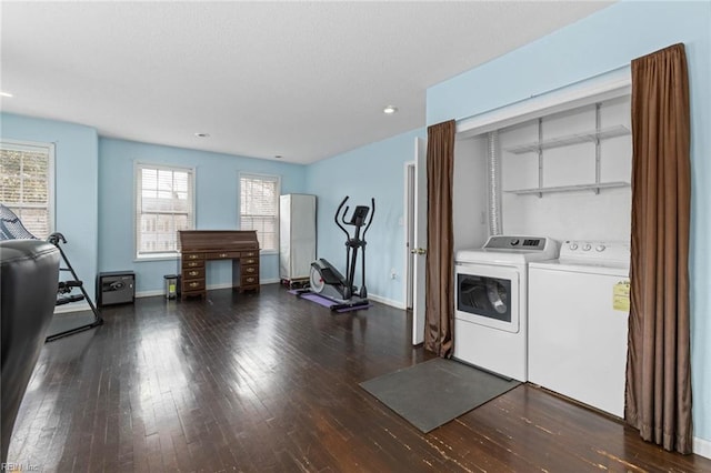 washroom featuring hardwood / wood-style floors, laundry area, baseboards, and washing machine and clothes dryer