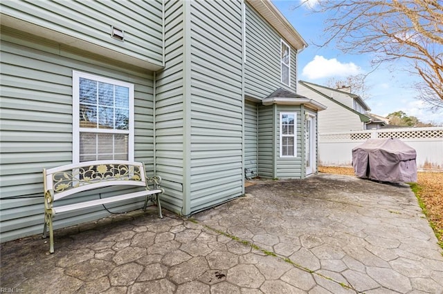 view of patio / terrace featuring a grill and fence