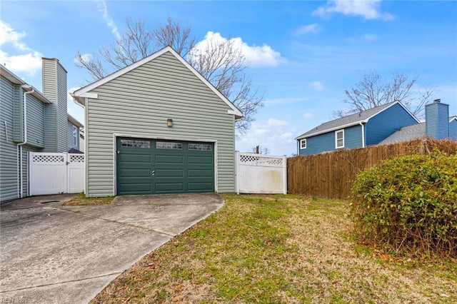 garage featuring fence and driveway