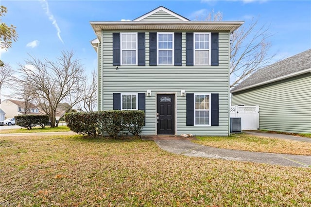 view of front of home with a front yard and fence