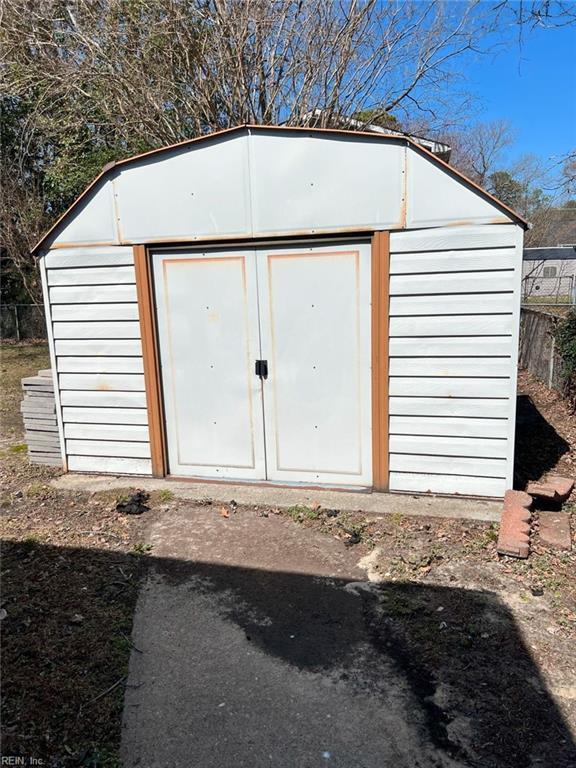 view of shed with fence